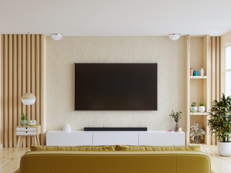 Wall-mounted TV with yellow sofa