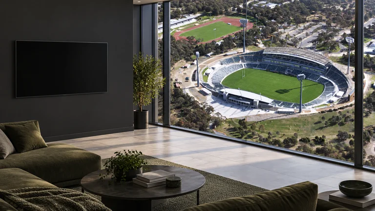 Bruce — Room concept with a wall-mounted TV and a view inspired by GIO Stadium Canberra.