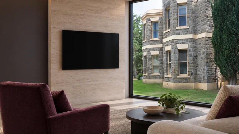 Crace — Room concept with a wall-mounted TV and a view inspired by Gungahlin Homestead sandstone wing.