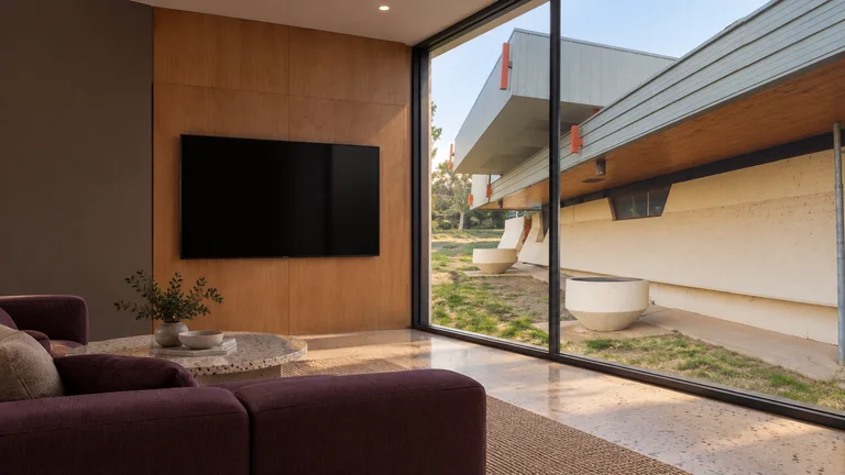 Flynn — Room concept with a wall-mounted TV and a view inspired by Former Flynn Primary School, now Flynn Community Hub.