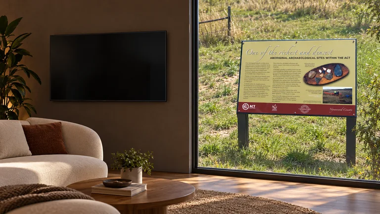 Macgregor — Room concept with a wall-mounted TV and a view inspired by West Macgregor archaeological-site marker.